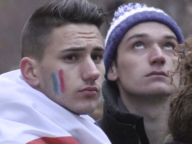 Young men attend a vigil outside the French consulate in Montreal Saturday, November 14 , 2015, for victims of the Paris terrorist attacks.