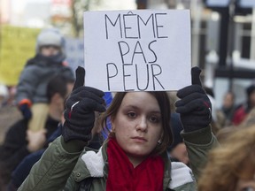 A woman holds a sign proclaiming she has no fear in Montreal Sunday, Nov. 15, 2015. during a march in solidarity with Paris.