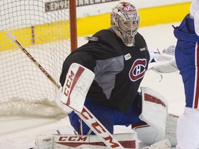 A puck flies past Canadiens goalie Carey Price during the  team's practice at the Bell Sports Complex in Brossard on Nov. 18, 2015.