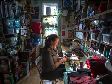 Genia Chepurniy at work in her home atelier in Montreal on Friday, November 20, 2015 creates mittens, scarves and pillows from recycled sweaters. (Dave Sidaway / MONTREAL GAZETTE)