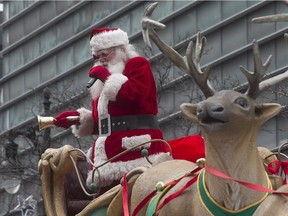 Santa shares best wishes to crowd during annual Santa parade in the streets on Montreal on Saturday Nov.  21, 2015.