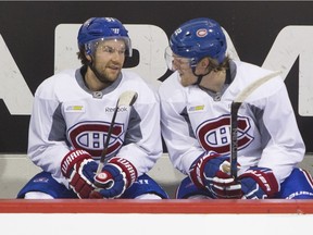Linemates David Desharnais (left) and Dale Weise chat on the bench during break in Canadiens practice at the Bell Sports Complex in Brossard on Nov. 24, 2015.