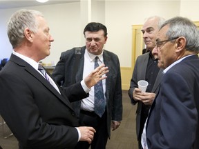 Paul Brunet, left, talks about health care conditions with Jérôme Di Giovanni, president of the Patient Alliance for Health, second from left, Michel Bissonnette and Jean Lacharité of the CSN, right, following a press conference by the Patient Alliance for Healh in Montreal, Tuesday November 24, 2015, to demand that the provincial government put in place guarantees in the health system to improve primary care.