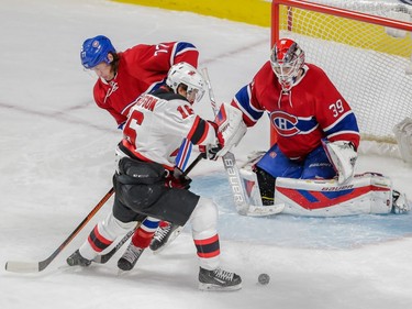 New Jersey Devils centre Jacob Josefson, foreground, attempts a shot against Montreal Canadiens goalie Mike Condon, right, and defenceman Tom Gilbert, left, during their NHL hockey match at the Bell Centre in Montreal on Saturday, November 28, 2015.