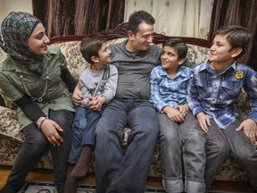 Syrian refugee Adham Mashael with his children, from left, Marwa, Yamen, Yazen and Mohamad Fahed in their home in Dollard des Ormeaux, west of Montreal Monday November 30, 2015.  Refugees from Syria, they have been in Canada since May of 2014.