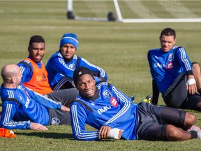 Impact forward Didier Drogba (foreground) rests with his teammates after practice in Montreal on Nov. 4, 2015.