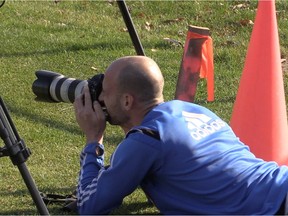 Impact defender Laurent Ciman borrows Montreal Gazette photographer Dave Sidaway's camera to snap some photos of his teammates at practice in Montreal on Nov. 5, 2015.
