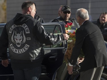 Flowers are placed in a limousine as hundreds of members of several motorcycle clubs from across Canada mingle outside the Alfred Dallaire Funeral Home in Repentigny on Saturday, November 7, 2015.