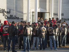 Hundreds of members of several motorcycle clubs from across Canada mingle outside the Alfred Dallaire Funeral Home in Repentigny on Saturday, Nov. 7, 2015. They attended the funeral of 63-year-old Lionel Deschamps, a member of Hells Angels Montreal chapter.
