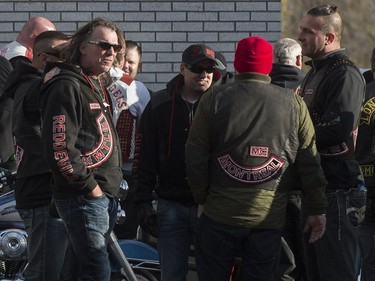 Hundreds of members of several motorcycle clubs from across Canada mingle outside the Alfred Dallaire Funeral Home in Repentigny on Saturday, November 7, 2015.