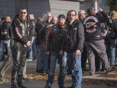 Hundreds of members of several motorcycle clubs from across Canada mingle outside the Alfred Dallaire Funeral Home in Repentigny on Saturday, November 7, 2015.