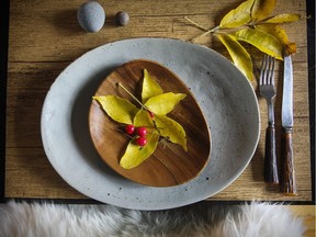 Bring the outdoors in with a fall table setting decorated with leaves, river rocks and a sheepskin over the chair.