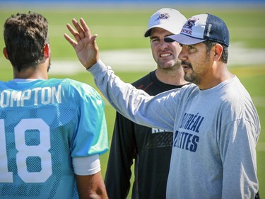 Montreal Alouettes co-offensive coordinators Ryan Dinwiddie and Anthony Calvillo, right work with quarterback Jonathan Crompton during practice in Montreal Wednesday September 16, 2015.