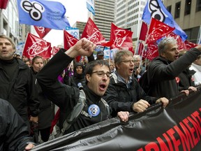 Teachers and supporters march and chant during a demonstration in downtown Montreal, Sept. 30, 2015, as part of a day of strikes at French language schools.