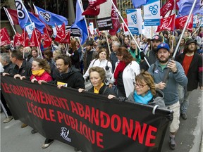 Teachers and supporters march and chant during a demonstration in downtown Montreal, Wednesday September  30, 2015, as part of a day of strikes at French language schools.
