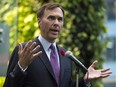 Finance Minister Bill Morneau talks to media in Ottawa, Tuesday, Nov.10, 2015. The new Trudeau government will have to contend with bigger-than-expected baseline deficits in the coming years as it starts rolling out the large spending plans that helped it win power, the federal budget watchdog says.