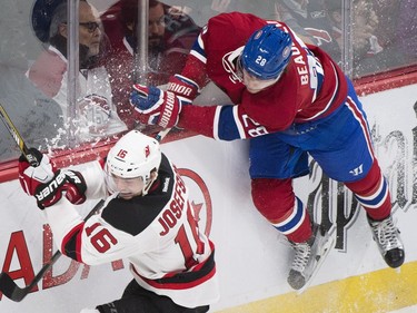 Montreal Canadiens' Nathan Beaulieu (28) collides with New Jersey Devils' Jacob Josefson during second period NHL hockey action, in Montreal, on Saturday, Nov. 28, 2015.