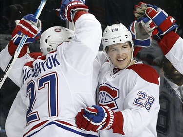 Montreal Canadiens defenceman Nathan Beaulieu (28) celebrates scoring a goal during the first period of an NHL hockey game against the New York Islanders on Friday, Nov. 20, 2015, in New York.