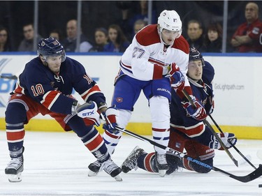 New York Rangers center J.T. Miller (10) and right wing Jesper Fast vie battle for the puck against Montreal Canadiens centre Alex Galchenyuk (27) during the first period of an NHL hockey game Wednesday, Nov. 25, 2015, in New York.