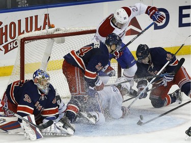 New York Rangers center Oscar Lindberg (24) and right wing Jesper Fast (19) try to clear the puck as Montreal Canadiens center David Desharnais (51) and right wing Dale Weise (22) look to score on a rebound against Rangers goalie Antti Raanta, left, during the third period of an NHL hockey game Wednesday, Nov. 25, 2015, in New York. The Canadiens won 5-1.