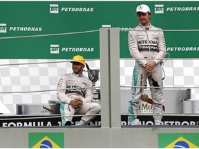 Mercedes drivers Nico Rosberg of Germany, right, and Mercedes driver Lewis Hamilton of Britain, are seen after attending the podium ceremony in the Formula One Brazilian Grand Prix at the Interlagos race track in Sao Paulo, Brazil, Sunday, Nov. 15, 2015.