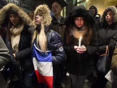 People attend a vigil outside the French consulate in Montreal, Friday, November 13, 2015. Canadian Prime Minister Justin Trudeau offered "all of Canada's support" to France on Friday night in the wake of "deeply worrying" terrorist attacks in Paris that killed at least 120 people.