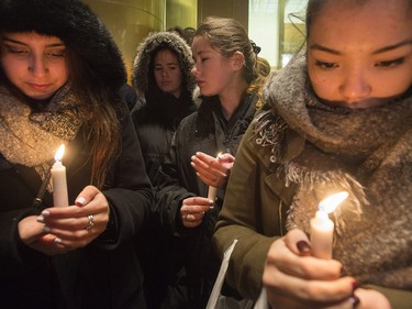 People attend a vigil outside the French consulate in Montreal, Friday, November 13, 2015. Canadian Prime Minister Justin Trudeau offered "all of Canada's support" to France on Friday night in the wake of "deeply worrying" terrorist attacks in Paris that killed at least 120 people.