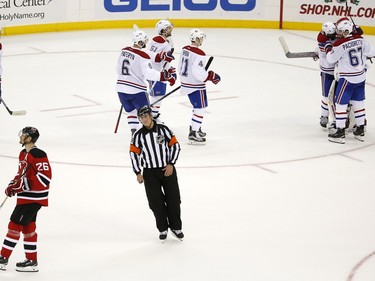 New Jersey Devils left wing Patrik Elias, bottom left, of the Czech Republic, skates away as Montreal Canadiens celebrate after Elias missed on a shot in the shootout during an NHL hockey game, Friday, Nov. 27, 2015, in Newark, N.J. The Canadiens won 3-2.