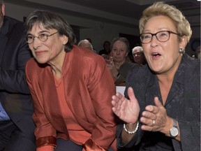Then-Quebec Premier and Parti Québécois Leader Pauline Marois, right, applauds Charlebourg candidate Dominique Payette at a nomination meeting, Tuesday, March 4, 2014 in Quebec City.