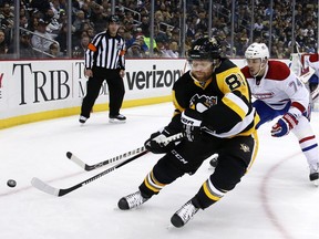 Penguins' Phil Kessel, front, makes a backhand pass in the corner in front of Canadiens' Alexei Emelin during the second period in Pittsburgh.