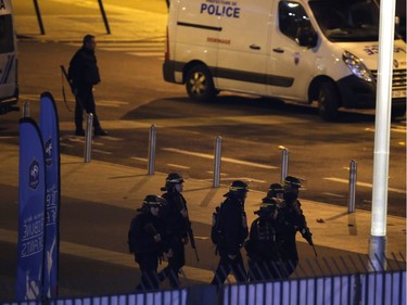 Police officers take position outside the Stade de France stadium after the international friendly soccer France against Germany, Friday, Nov. 13, 2015 in Saint Denis, outside Paris. At least 35 people were killed in shootings and explosions around Paris, many of them in a popular theater where patrons were taken hostage, police and medical officials said Friday.