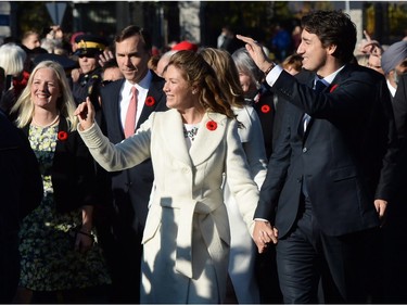 Prime Minister-designate Justin Trudeau and his wife Sophie Grégoire-Trudeau lead the new Liberal cabinet to Rideau Hall in Ottawa on Wednesday, Nov. 4, 2015.