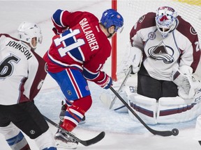 Montreal Canadiens' Brendan Gallagher (11) moves in on Colorado Avalanche's goaltender Reto Berra as the Avalanche's Erik Johnson (6) defends during second period NHL hockey action in Montreal, Saturday, November 14, 2015.