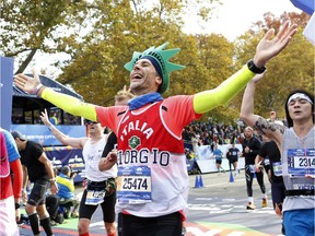 Marathons aren't just for the youngest runners. Runners react as they cross the finish line at the New York City Marathon in New York, Sunday, Nov. 1, 2015.