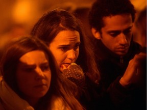 People pay tribute outside Le Carillon bar, the day after a deadly attack on Nov. 14, 2015 in Paris, France. At least 120 people have been killed and over 350 injured, 99 of which seriously, following a series of terrorist attacks in the French capital.