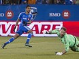 The Impact's Johan Venegas, left, scores against Columbus goalkeeper Steve Clark Sunday, Nov. 1, 2015 at Saputo Stadium