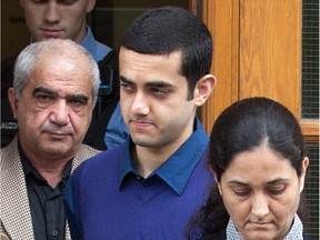 Mohammad Shafia, Hamed and Tooba Mohammad Yahya leave the courtroom for a lunchbreak during their murder trial at the Frontenac Court courthouse in Kingston Oct. 20, 2011.