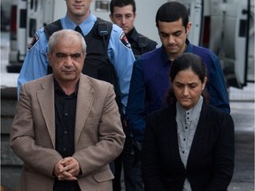 Mohammad Shafia, left, his son Hamed, back right, and Tooba Mohammad Yahya walk into the Frontenac Court courthouse in Kingston Ontario on October 20, 2011.