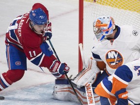 The Canadiens' Brendan Gallagher digs for puck in front of New York Islanders goalie Thomas Greiss during NHL game at the Bell Centre in Montreal on Nov. 22, 2015.
