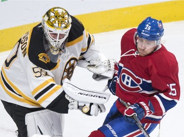 Boston Bruins' goalie Jonas Gustavsson, left, fends off Montreal Canadiens' Tomas Fleischmann during first period NHL hockey action, in Montreal, on Saturday, Nov. 7, 2015.