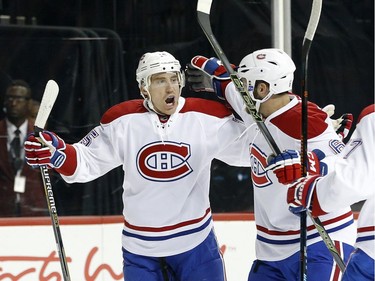Montreal Canadiens' Tomas Fleischmann, left, celebrates his goal with a teammate during the first period of an NHL hockey game against the New York Islanders on Friday, Nov. 20, 2015, in New York.