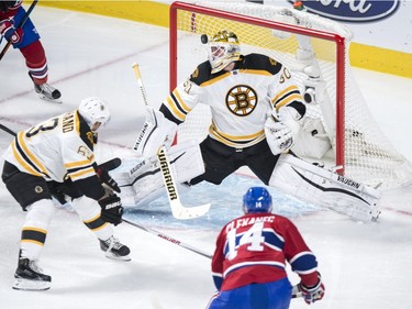 Montreal Canadiens' Tomas Plekanec (14) scores past Boston Bruins' goalie Jonas Gustavsson (50) as teammate Brad Marchand (63) looks on during second period NHL hockey action, in Montreal, on Saturday, Nov. 7, 2015.