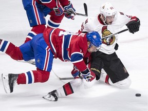 Canadiens' Tomas Plekanec, left, falls during a challenge to Senators' Mika Zibanejad for the puck during third period NHL hockey action, in Montreal, on Tuesday, Nov. 3, 2015.