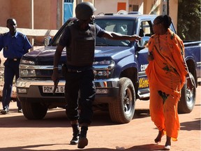 Malian security forces remove two women from an area surrounding the Radisson Blu hotel in Bamako Nov. 20, 2015. Gunmen went on a shooting rampage at the luxury hotel in Mali's capital Bamako, seizing 170 guests and staff in an ongoing hostage-taking that has left at least three people dead.