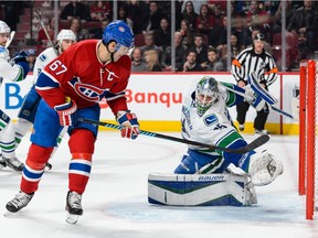 Max Pacioretty of the Montreal Canadiens gets the puck past goaltender Jacob Markstrom of the Vancouver Canucks and scores during the NHL game at the Bell Centre on Monday.