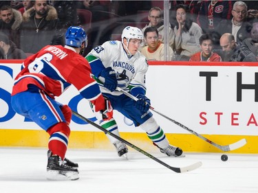 Bo Horvat #53 of the Vancouver Canucks looks to play the puck past Greg Pateryn #6 of the Montreal Canadiens during the NHL game at the Bell Centre on November 16, 2015 in Montreal, Quebec, Canada.