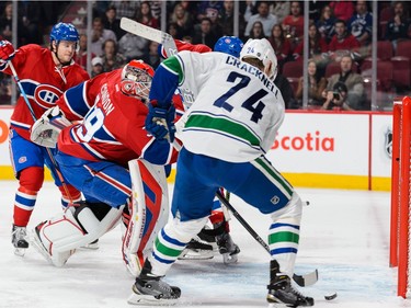 Goaltender Mike Condon #39 of the Montreal Canadiens is caught out of position as Adam Cracknell #24 of the Vancouver Canucks shoots the puck towards the net during the NHL game at the Bell Centre on November 16, 2015 in Montreal, Quebec, Canada.