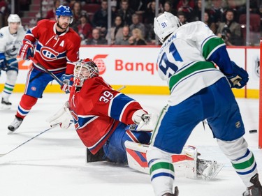 Jared McCann #91 of the Vancouver Canucks shoots the puck towards the net of goaltender Mike Condon #39 of the Montreal Canadiens during the NHL game at the Bell Centre on November 16, 2015 in Montreal, Quebec, Canada.