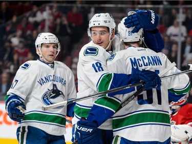 Jared McCann #91 of the Vancouver Canucks celebrates his goal with teammate Jake Virtanen #18 during the NHL game against the Montreal Canadiens at the Bell Centre on November 16, 2015 in Montreal, Quebec, Canada.