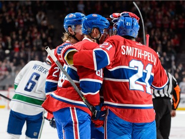Lars Eller #81 of the Montreal Canadiens celebrates a shorthanded goal with teammates during the NHL game against the Vancouver Canucks at the Bell Centre on November 16, 2015 in Montreal, Quebec, Canada.